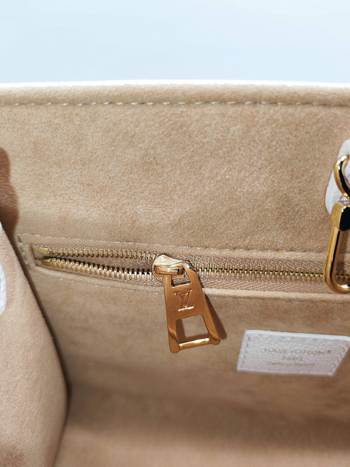Louis Vuitton OnTheGo PM in Pale Pink Monogram Empreinte Couture Cowhide Leather and Gold Hardware Microchip