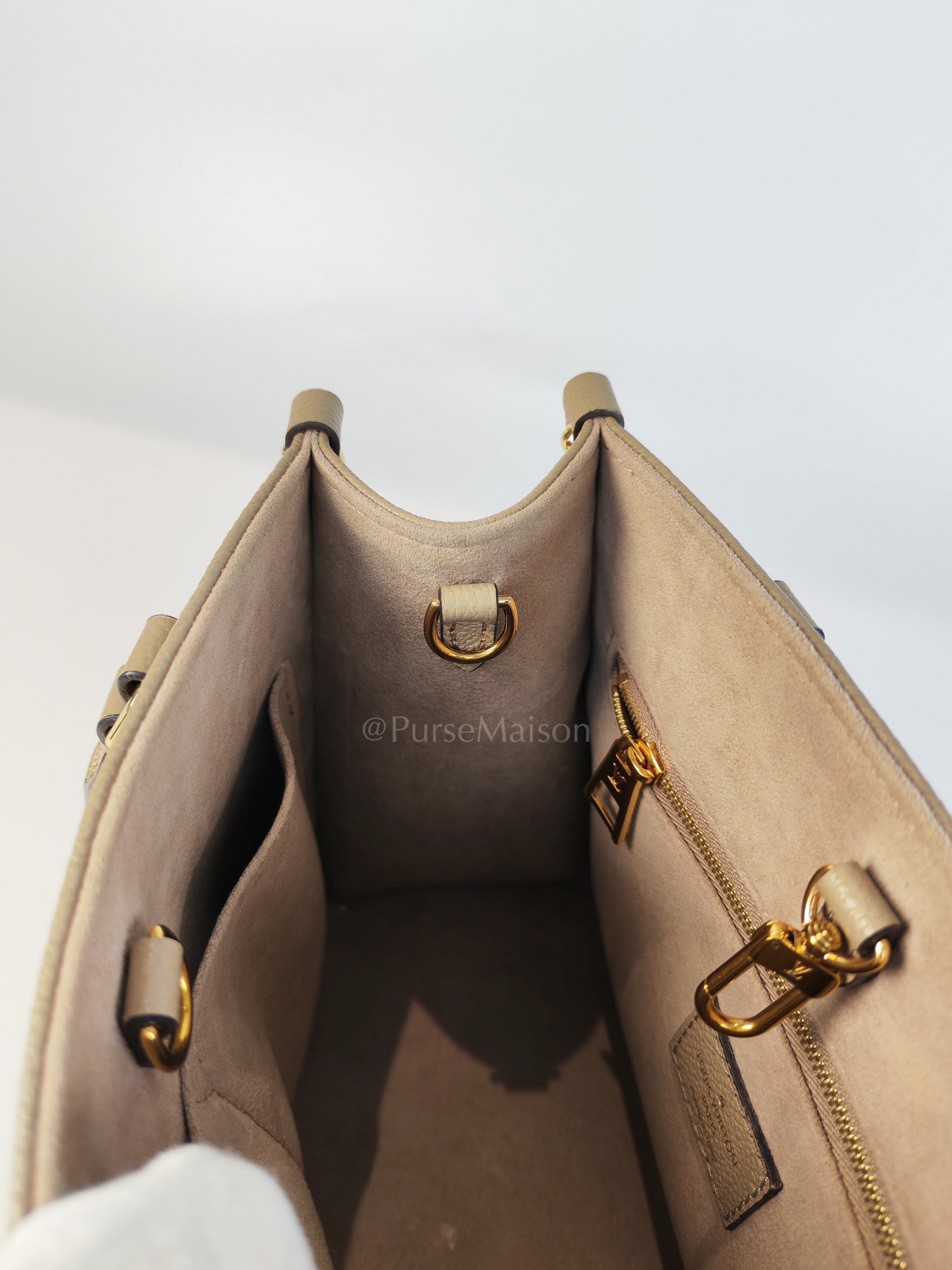 On The Go PM (OTG) in Tourterelle Creme in Monogram Empreinte Leather (Microchip) | Purse Maison Luxury Bags Shop