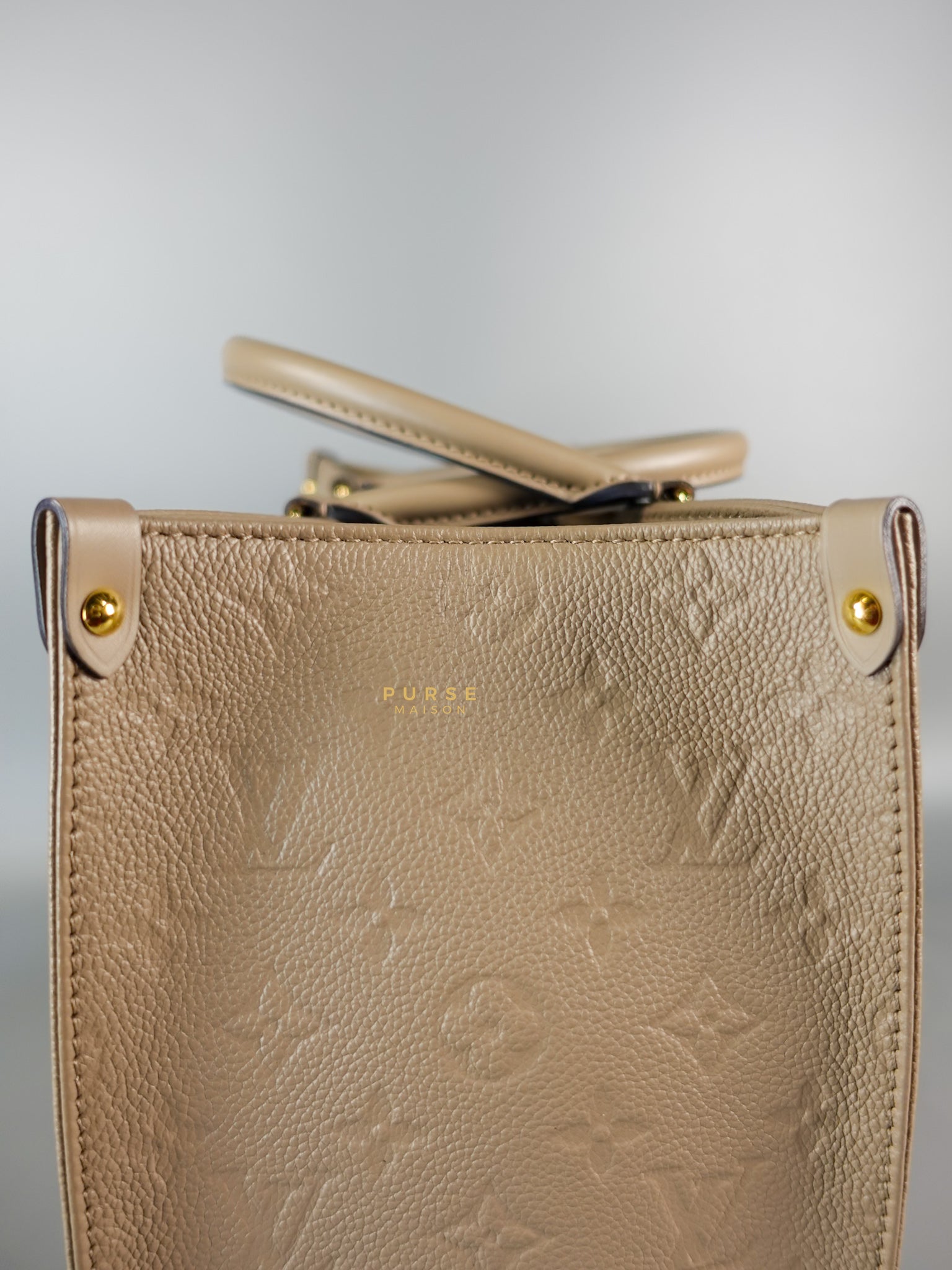 OnTheGo MM Tourterelle Empreinte Leather | Purse Maison Luxury Bags Shop