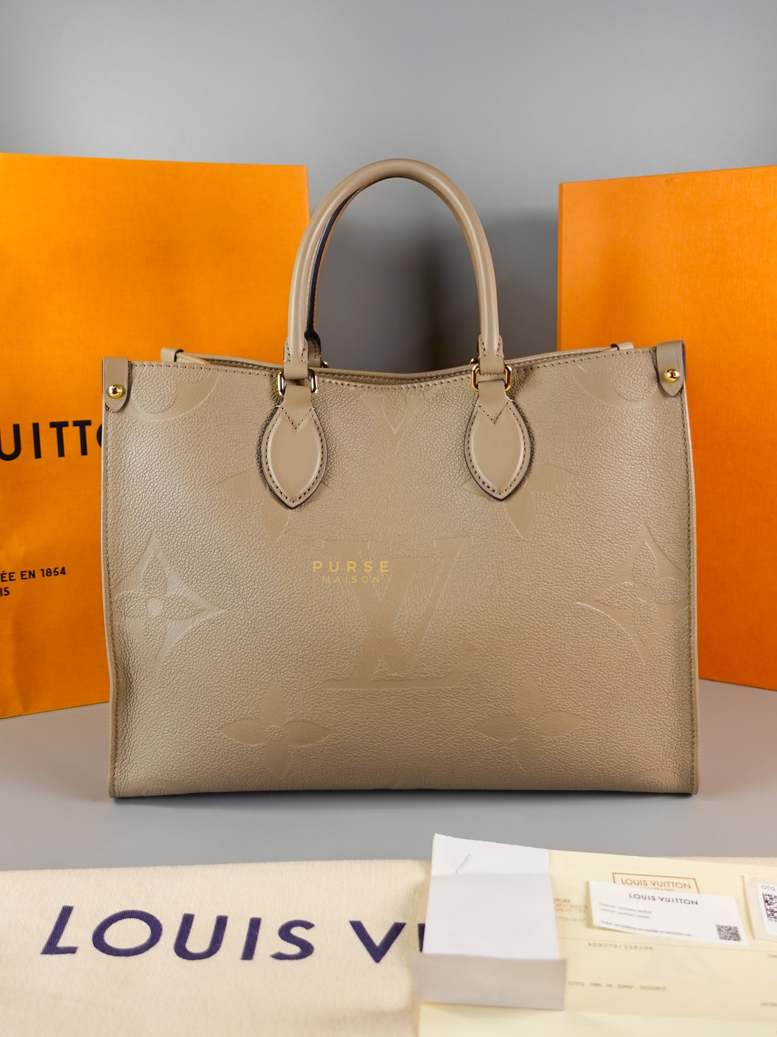 OnTheGo MM Tourterelle Empreinte Leather | Purse Maison Luxury Bags Shop