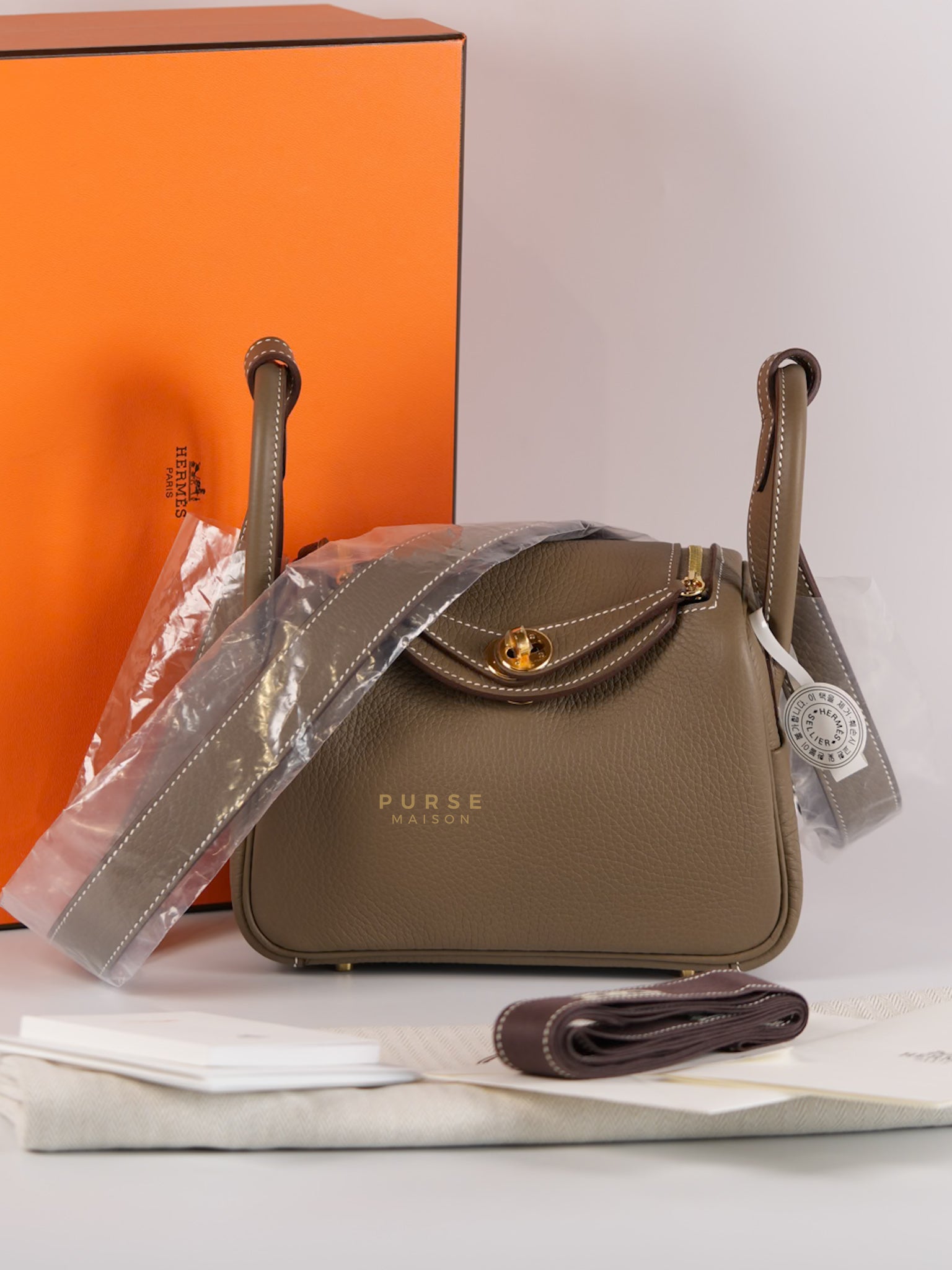 Mini Lindy Etoupe in Taurillion Clemence Leather and Gold Hardware Stamp W (2024) | Purse Maison Luxury Bags Shop