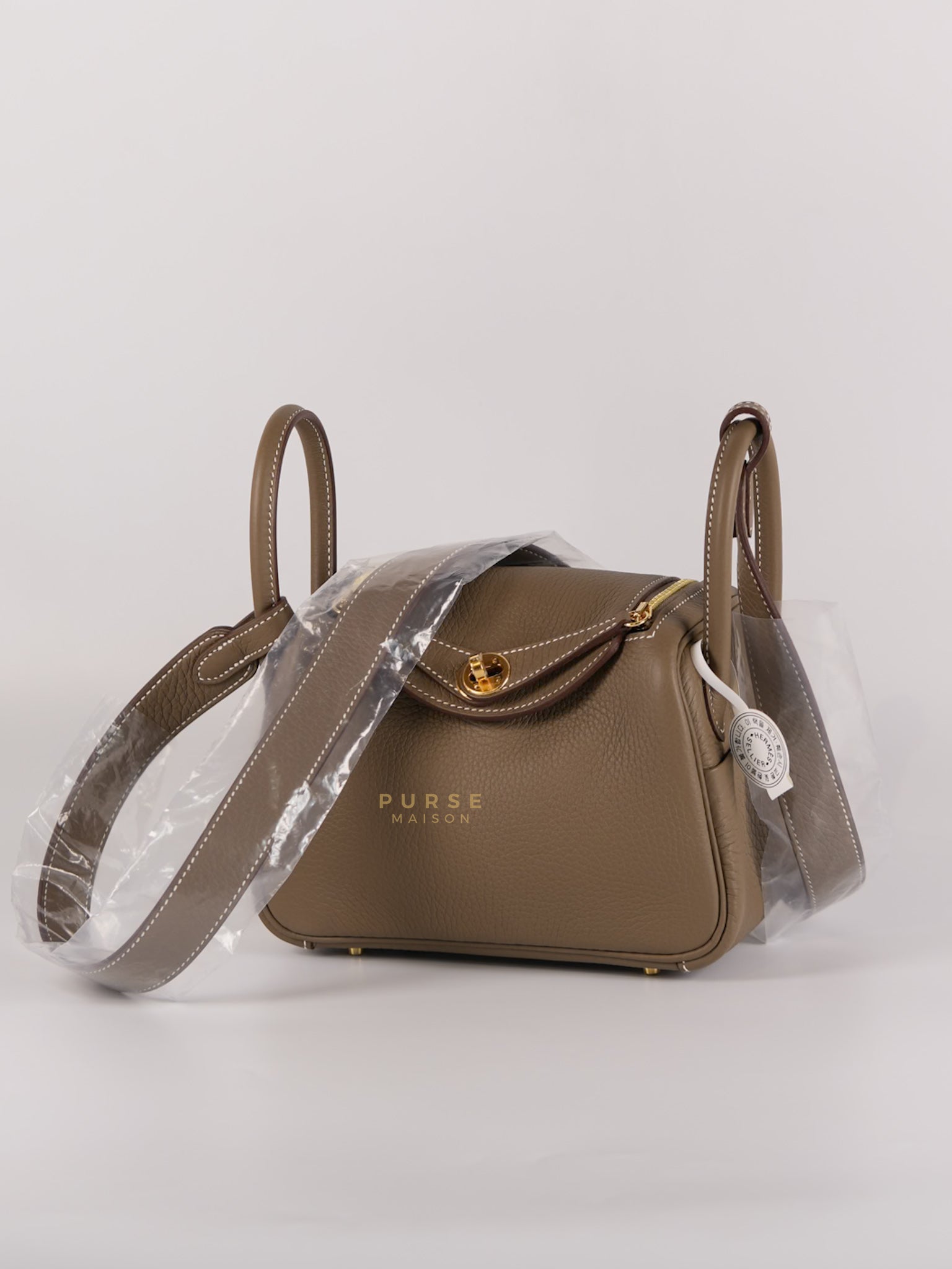 Mini Lindy Etoupe in Taurillion Clemence Leather and Gold Hardware Stamp W (2024) | Purse Maison Luxury Bags Shop